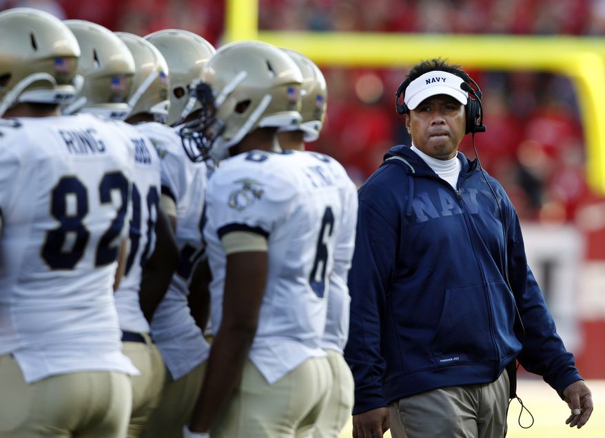 FILE - In this Saturday, Oct. 15, 2011 file photo, Navy head coach Ken Niumatalolo, right, stands with his players during the second half of an NCAA college football game against Rutgers in Piscataway, N.J. Rutgers won 21-20. For the first time since 2003, the Midshipmen are coming off a losing season. After going 5-7 and having their run of eight straight bowl bids end, the Midshipmen enter the 2012 season with a sense of urgency. (AP Photo/Mel Evans, File)