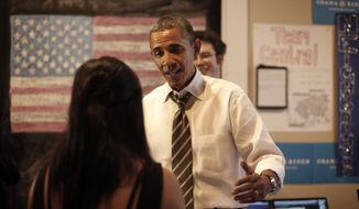 President Obama stops to greet campaign workers at the Obama for America field office in Charlottesville, Va., on Wednesday, Aug. 29, 2012. (AP Photo/Pablo Martinez Monsivais)
