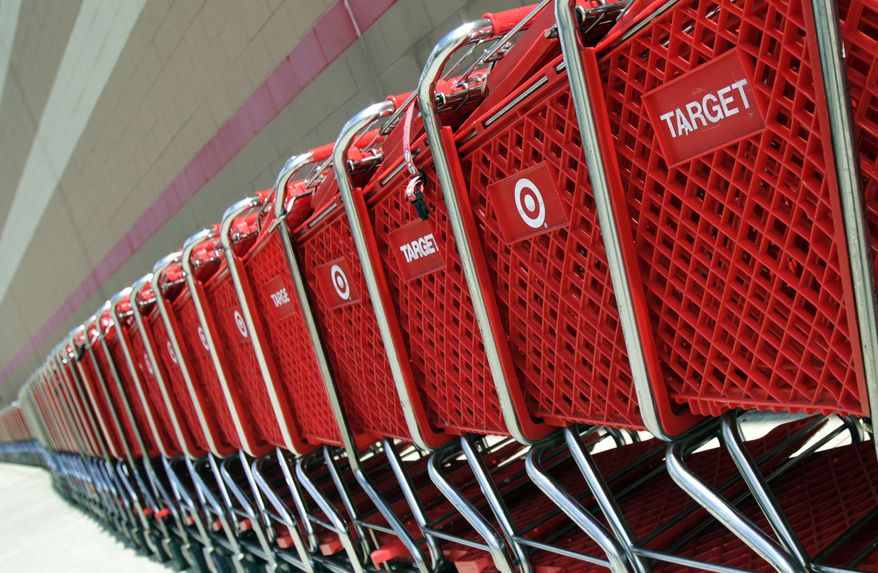 **FILE** Shopping carts sit parked outside a Target store in Marlborough, Mass., on July 28, 2012. (Associated Press)