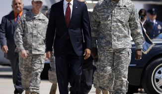 President Obama walks Aug. 31, 2012, on the tarmac upon his arrival at Biggs Airfield at Fort Bliss, Texas, with Gen. Lloyd Austin (right), vice chief of staff of the U.S. Army, to greet members of the military and their families. (Associated Press)