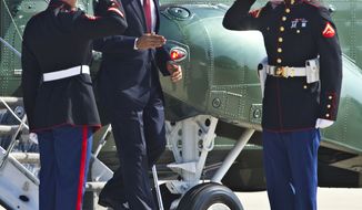 President Obama disembarks Marine One on Aug. 31, 2012, on his way to switch to Air Force One at Andrews Air Force Base, Md., for a trip to Fort Bliss in Texas. (Associated Press)