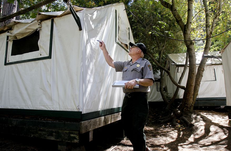 FILE - In a Tuesday Aug. 28, 2012 photo, Glenn Dean, a National Parks Occupational Safety and Health Specialist, inspects tent cabins for mice entry points at Curry Village at Yosemite National Park. Two more Yosemite National Park visitors have been found with a mouse-borne virus blamed for the deaths of two people, bringing the total number of infections to six, state health officials said. (AP Photo/San Francisco Chronicle, Michael Macor)