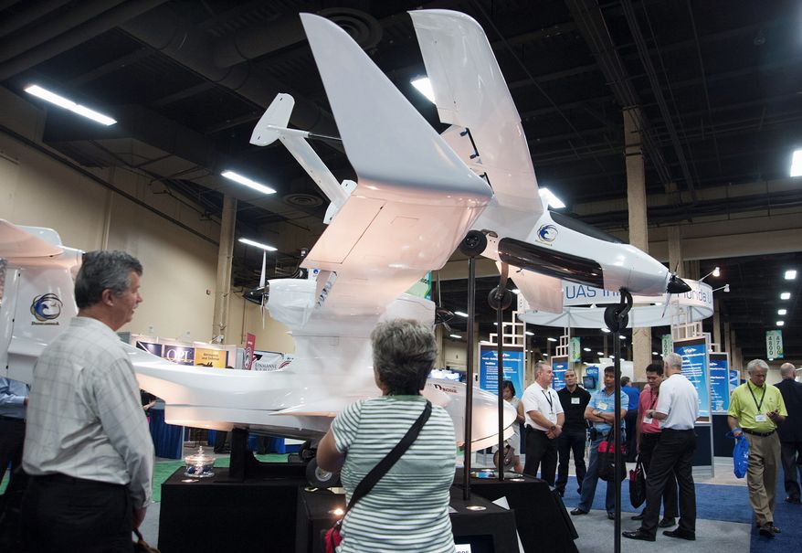 Attendees, of the Association for Unmanned Vehicle Systems International, North America 2012 conference checks out one of the exhibits displayed inside the exhibition hall of the Mandalay Bay hotel-casino in Las Vegas, Nev., on Wednesday, August 8, 2012. (Martin S. Fuentes/Special to The Washington Times)