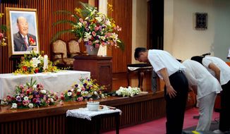 Followers pay their respects to the Rev. Sun Myung Moon at a Unification Church in Tokyo on Monday, Sept. 3, 2012. Rev. Moon died Monday, Sept. 3, 2012, at a church-owned hospital near his home in Gapyeong County, northeast of Seoul, church officials said. He was 92. (AP Photo/Koji Sasahara)