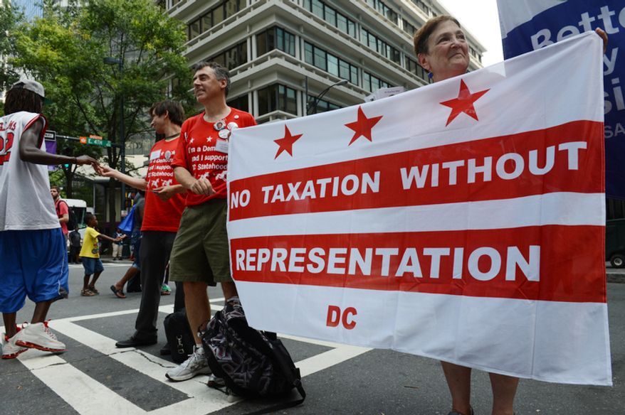 Proponents of DC statehood, from left, David Lowell, John Cappozi and Ann Howell hand out literature outside the Democratic National Convention. DC Mayor Vincent Gray will speak during the convention. (Barbara Salisbury/ The Washington Times)