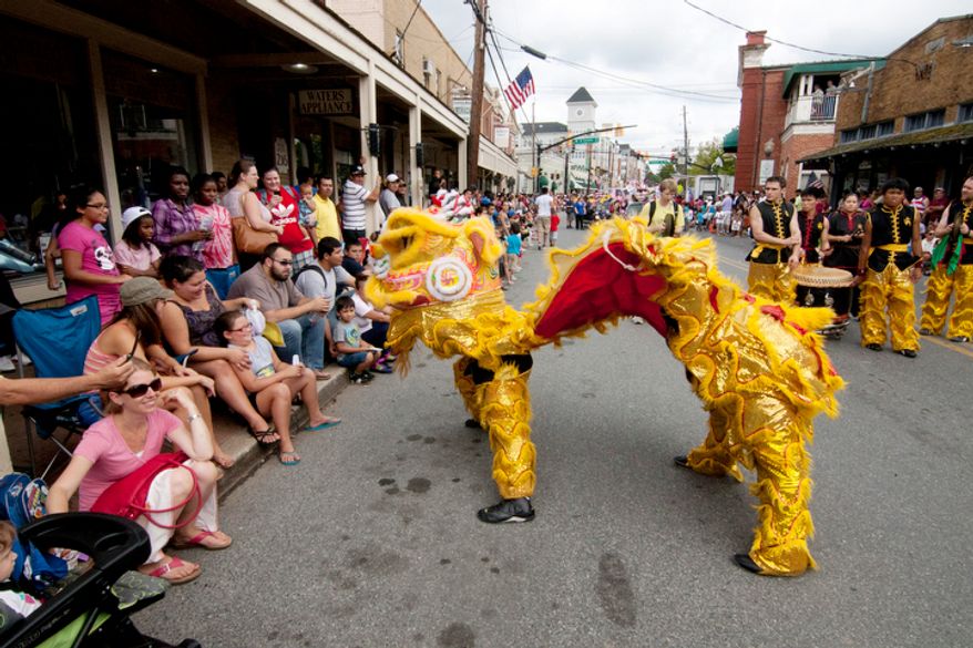 A giant dragon was one of 80 groups participating in the three hour long parade in Gaithersburg. (Craig Bisacre/The Washington Times)