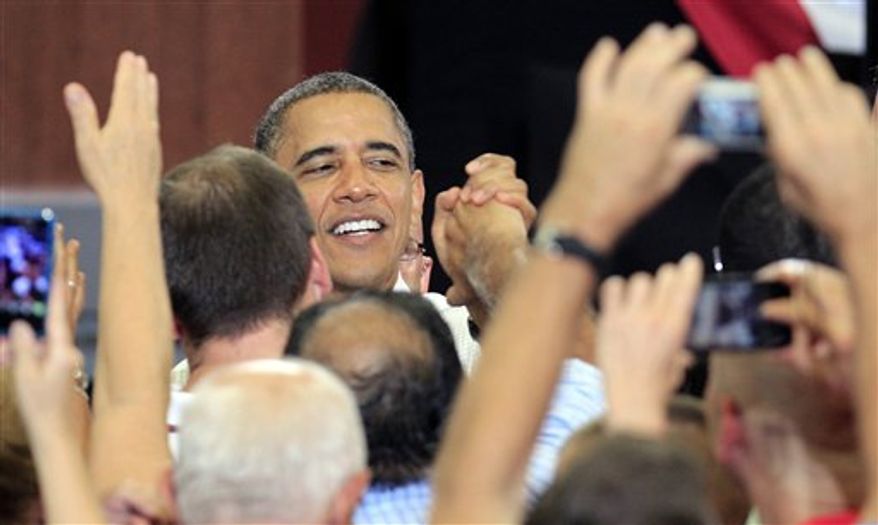 President Obama shakes hands with supporters after speaking at a campaign event at Scott High School Monday, Sept. 3, 2012, in Toledo, Ohio. (AP Photo/Tony Dejak)