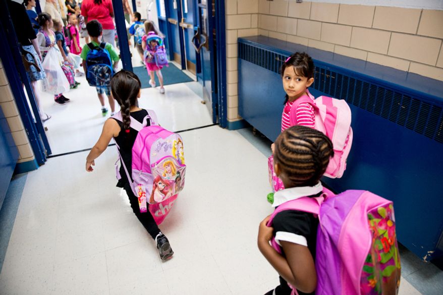 Children make their way to class on the first day back to school at North Springfield Elementary School. (Andrew Harnik/The Washington Times)