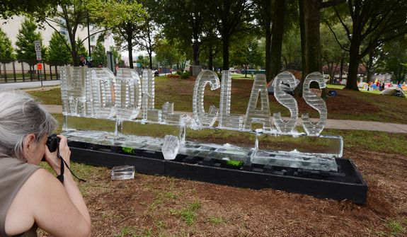A woman takes a picture of an ice sculpture that says &quot;Middle Class&quot; on Tuesday, Sept. 3, 2012 in Marshall Park in Charlotte, N.C., which has been taken over by the Occupy movement during the Democratic National Convention. The sculpture, which was made by artists Ligorano and Reese, is called &quot;Morning in America&quot; and is supposed to represent the fact that the middle class is disappearing like ice. (Barbara L. Salisbury/The Washington Times)