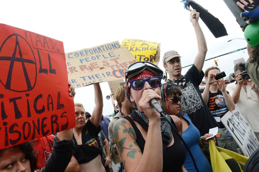 Lauren Digioia, center, of New York City, who is a member of the Occupy Wall Street movement, talks to fellow protesters on the streets of Charlotte, N.C. outside the Democratic National Convention. Although they were given a designated "free speech zone," protesters preferred to stay in the street. (Barbara L. Salisbury/The Washington Times)