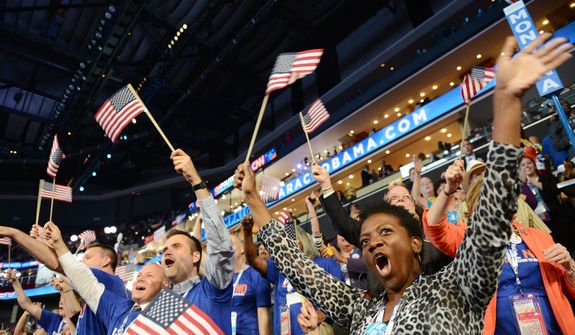 Minnesota delegate Katrina Wilder, from St. Cloud, Minn., cheers a speaker during the first night of the Democratic National Convention. (Barbara Salisbury/ The Washington Times)
