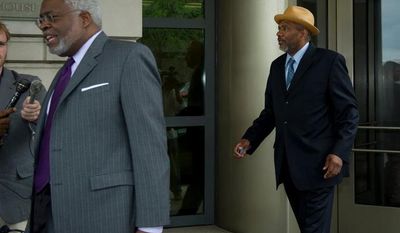 Following his attorney Frederick D. Cooke, Jr., (left) Thomas Gore, a campaign treasurer for Mayor Vincent C. Gray, makes his exit from the E. Barrett Prettyman Federal Courthouse after his plea hearing in the District on Tuesday, May 22, 2012. (Rod Lamkey Jr/The Washington Times)
