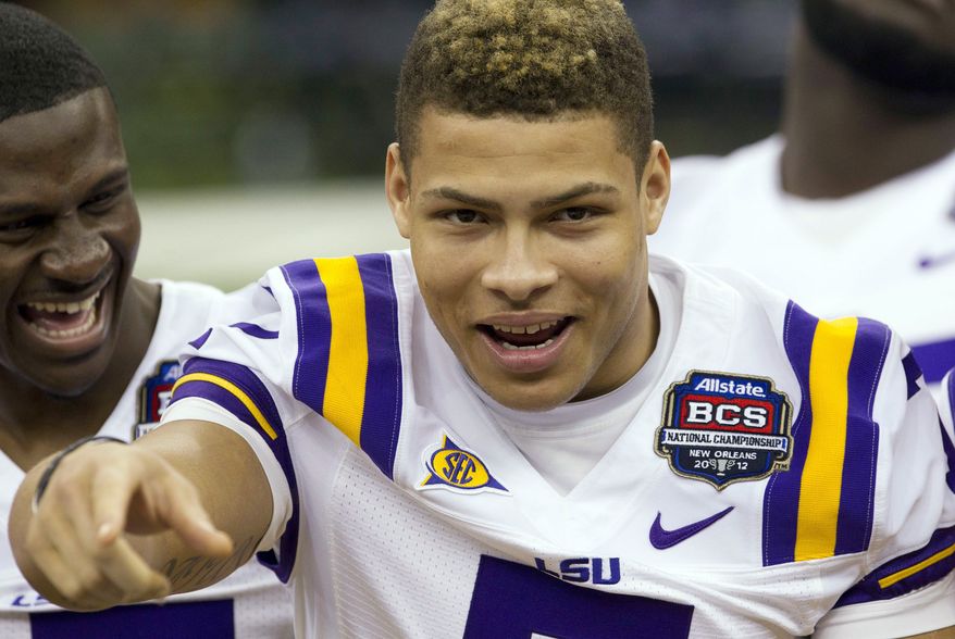 FILE - This Jan. 6, 2012 file photo shows LSU cornerback Tyrann Mathieu smiling and gesturing as he waits for the team portrait during media day for the BCS championship NCAA college football game at the Superdome in New Orleans. The former LSU star has entered a drug rehabilitation program in Houston since being dismissed from the Tigers, according to a television report. Fox 8 reports that Mathieu's adoptive father, Tryone Mathieu, says that the 20-year-old star cornerback and punt returner known as the "Honey Badger" has been at the Right Step recovery center and is being counseled by former NBA player John Lucas. (AP Photo/Dave Martin, File)