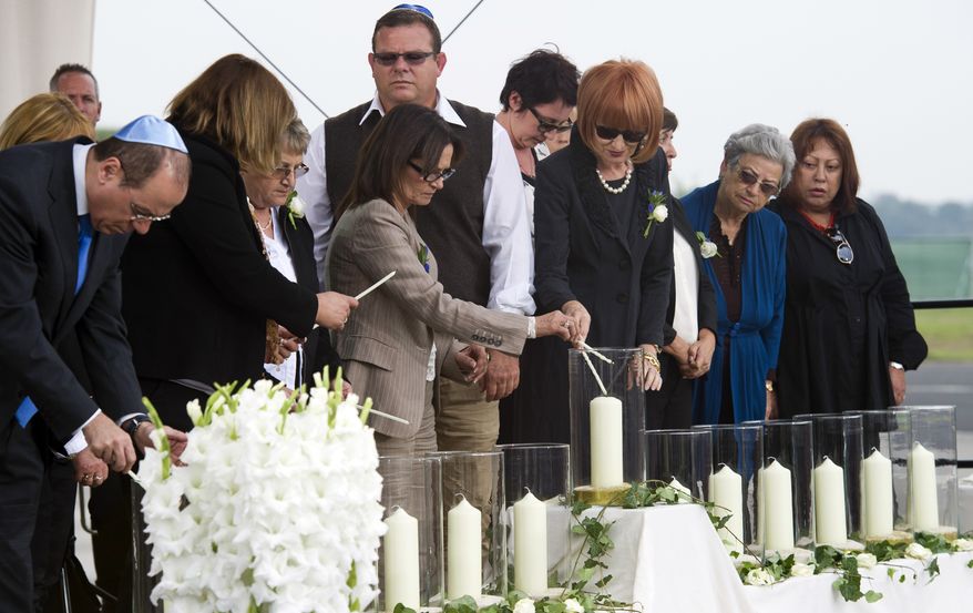 Israel's deputy Prime Minister Silvan Shalom and relatives light candles during a commemoration ceremony for the assassination victims of the Olympic games in Munich in 1972, at the former airbase in Fuerstenfeldbruck, southern Germany, Wednesday, Sept. 5, 2012. Relatives of Israelis slain by Palestinian gunmen during the games and survivors of the attack are marking its 40th anniversary with German politicians and Jewish leaders at the air base where most of the 12 victims died. Also five terrorists were killed in the failed liberation attempt. (AP Photo/dapd, Lennart Preiss)