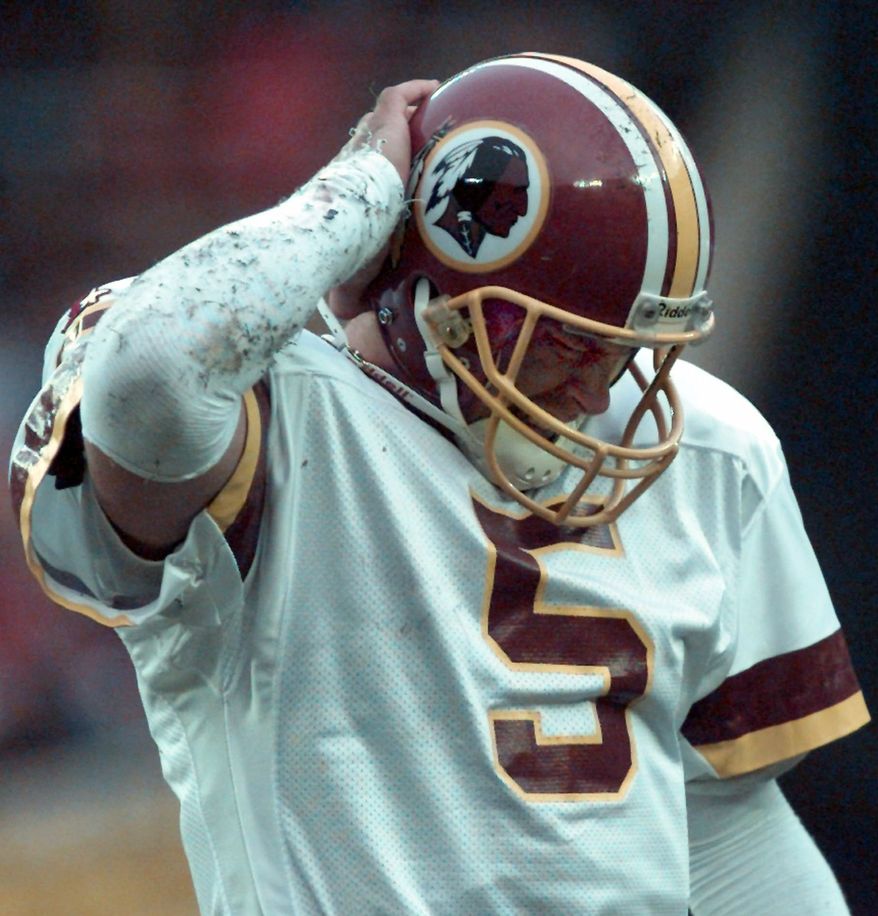 Washington Redskins quarterback Heath Shuler puts his hand to his helmet during the Redskins 14-7 loss to the Philadelphia Eagles Sunday, Nov. 26, 1995 at RFK Stadium. Shuler, starting his first game since the season opener, was 12 for 27 for 164 yards. (AP Photo/Doug Mills)