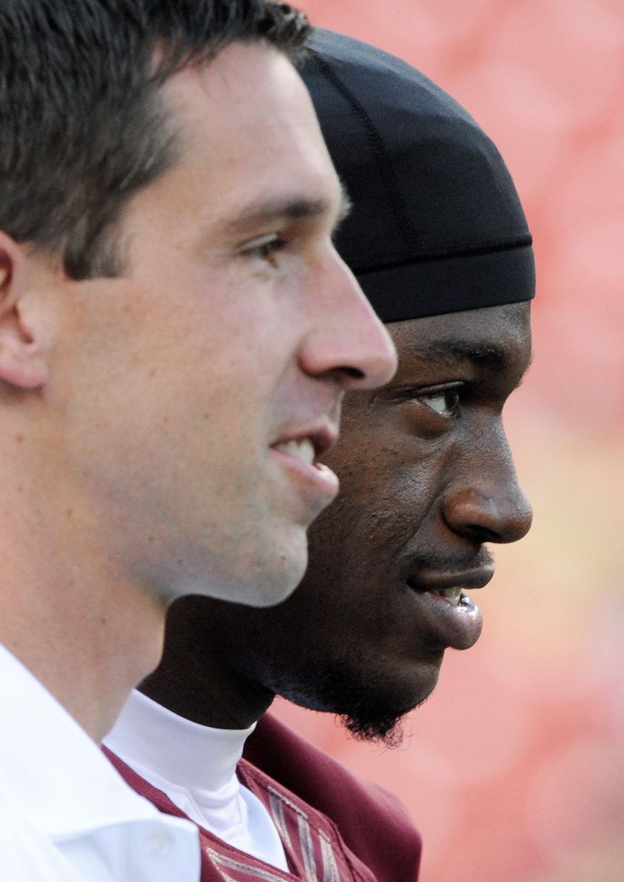 Washington Redskins head coach Kyle Shanahan and quarterback Robert Griffin III (10) watch warmups before the start of the final preseason game at FedEx Field, Landover, Md., Aug. 29, 2012. (Preston Keres/Special to The Washington Times)