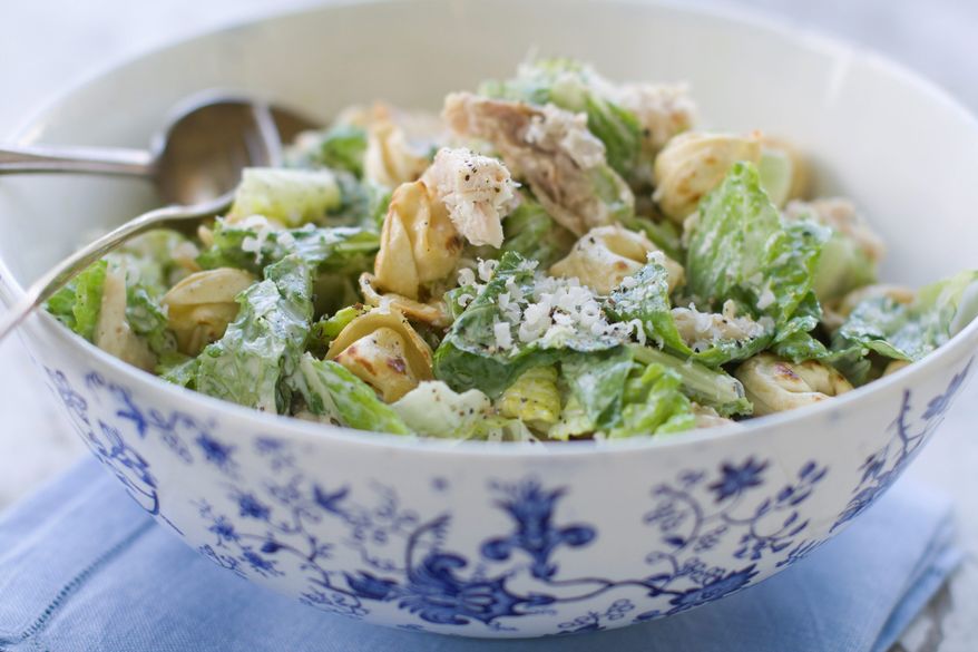 Chunks of chicken and cheese tortellini make Caesar salad more hearty. This version, inspired by cookbook author April Bloomfield, also gets a boy to eat his greens. (Associated Press)