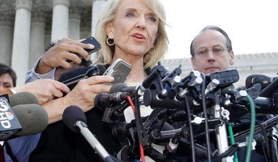Gov. Jan Brewer two years ago signed landmark legislation requiring all Arizona police officers to check the immigration status of people they stop while enforcing other laws and suspect are in the country illegally. The requirement is expected to go into effect in the next several days. (Associated Press)