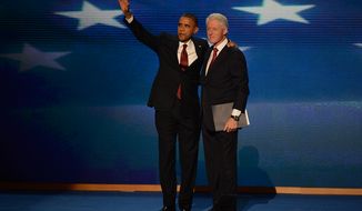 President Obama joins former President Bill Clinton after Clinton addressed the Democratic National Convention at the Time Warner Arena in Charlotte, N.C., on Sept. 5, 2012. (Andrew Geraci/The Washington Times)