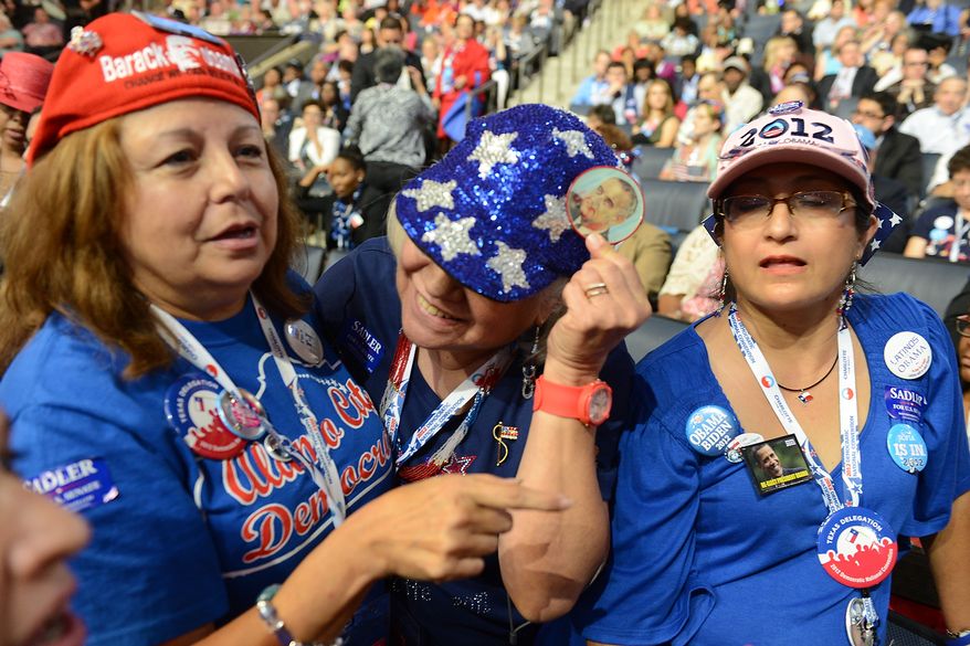 Texas delegates Tina Guerrera, left, Mildred Hilbrich and Sofia Moreno-Castillo of San Antonio, Tex., show off Hilbrich's LBJ button during the Democratic National Convention at the Time Warner Arena in Charlotte, N.C., on Wednesday, September 5, 2012. (Barbara Salisbury/ The Washington Times)