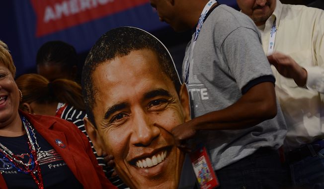 A delegate holds a face of President Obama on the night he accepts his party&#x27;s nomination for a second term at the Democratic National Convention in the Time Warner Arena in Charlotte, N.C., on Sept. 6, 2012. (Barbara Salisbury/The Washington Times)