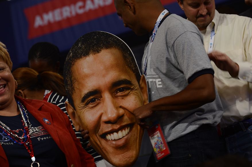 A delegate holds a face of President Obama on the night he accepts his party&#39;s nomination for a second term at the Democratic National Convention in the Time Warner Arena in Charlotte, N.C., on Sept. 6, 2012. (Barbara Salisbury/The Washington Times)