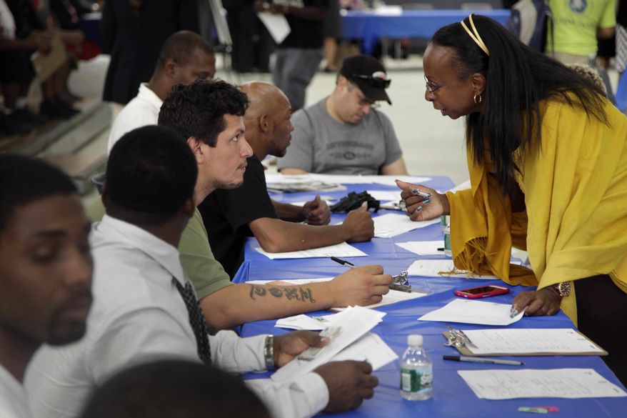 ** FILE ** In this Tuesday, Aug. 21, 2012, file photo, job seekers fill out applications at a construction job fair in New York. (AP Photo/Seth Wenig, File)