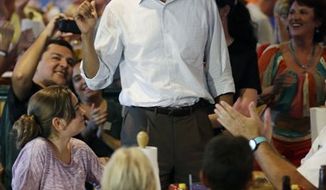 President Obama greets patrons Sept. 8, 2012, during an unscheduled stop at Gator&#39;s Dockside in Orlando, Fla. (Associated Press)
