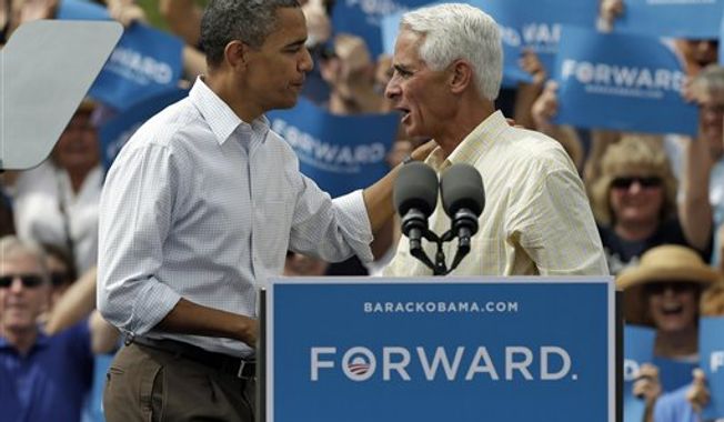 President Obama (left) talks with former Florida Gov. Charlie Crist on Sept. 8, 2012, at a campaign rally in Seminole, Fla. (Associated Press)