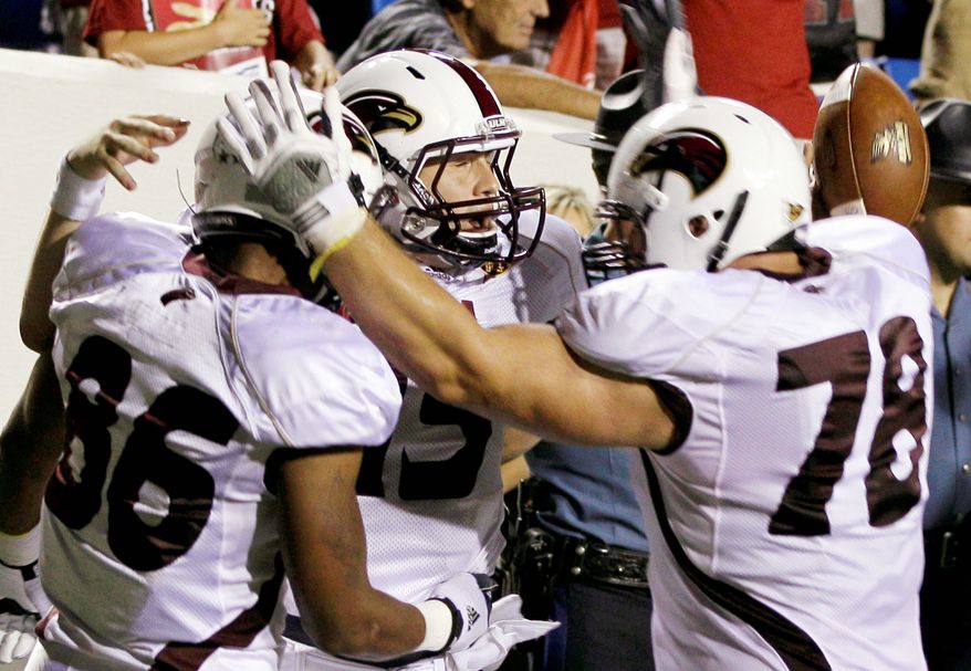 associated press
Louisiana Monroe quarterback Kolton Browning (center) celebrates with teammates after rallying the Warhawks from a 28-7 deficit to a 34-31 overtime victory over Arkansas. Next up for the Razorbacks is a visit from SEC power Alabama.