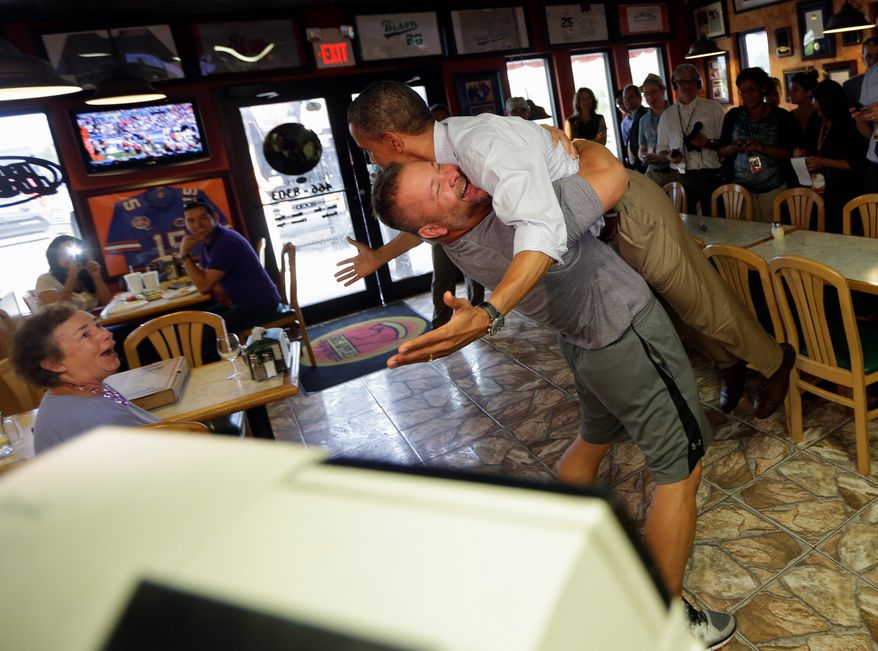 President Obama is lifted off the ground by Scott Van Duzer, owner of Big Apple Pizza and Pasta Italian Restaurant, on Sept. 9, 2012, during an unannounced stop at the restaurant in Ft. Pierce, Fla. (Associated Press)