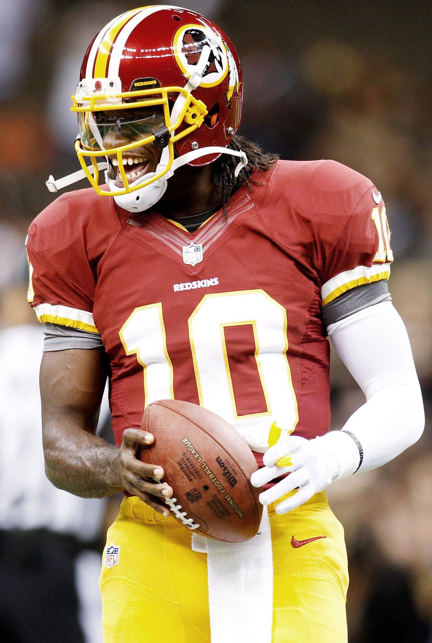 Washington Redskins quarterback Robert Griffin III (10) warms up before an NFL football game against the New Orleans Saints at the Mercedes-Benz Superdome in New Orleans, Sunday, Sept. 9, 2012. (AP Photo/Bill Haber)