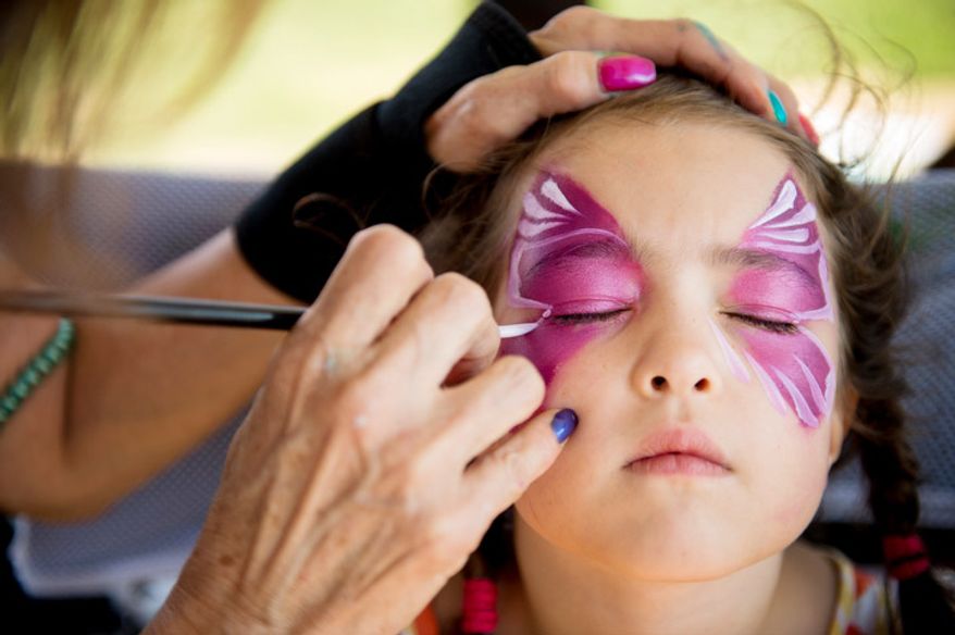 Rosemary Sellers, 6, of Washington, D.C. gets her face painted during the 34th annual Adams Morgan Day Festival. (Andrew Harnik/The Washington Times