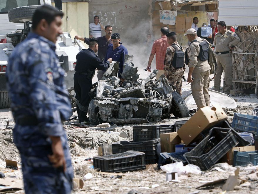Security forces inspect the scene of a car bombing in Basra, Iraq, 340 miles southeast of Baghdad, on Sunday, Sept. 9, 2012. (AP Photo/Nabil al-Jurani)