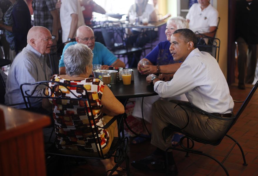 President Obama (right) sits with patrons (from left to right) John and Shirley Hill and Gerry and Jan Clark during his visit to Ossorio Bakery and Cafe in Cocoa, Fla., on Sunday, Sept. 9, 2012. (AP Photo/Pablo Martinez Monsivais)