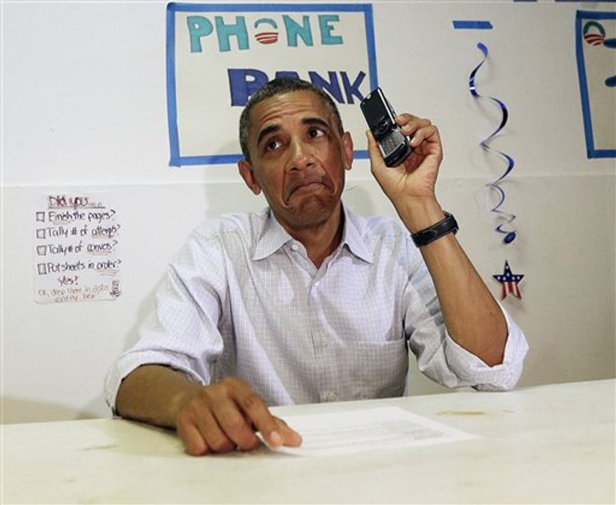 President Obama uses a cellphone to contact supporters during a surprise visit to meet volunteers at an Obama campaign office in Port St. Lucie, Fla. on Sept. 9, 2012. (Associated Press) **FILE**
