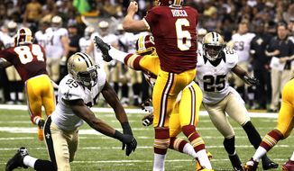New Orleans Saints defensive end Martez Wilson (95) blocks a punt by Washington Redskins punter Sav Rocca (6) resulting in a Saints touchdown in the first half of an NFL football game in New Orleans, Sunday, Sept. 9, 2012. (AP Photo/Bill Haber)