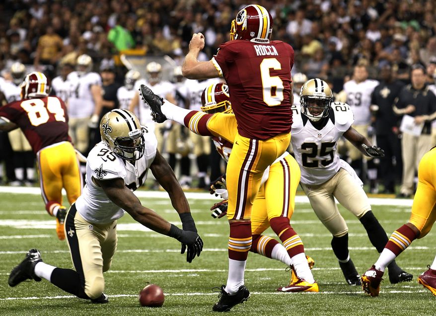New Orleans Saints defensive end Martez Wilson (95) blocks a punt by Washington Redskins punter Sav Rocca (6) resulting in a Saints touchdown in the first half of an NFL football game in New Orleans, Sunday, Sept. 9, 2012. (AP Photo/Bill Haber)