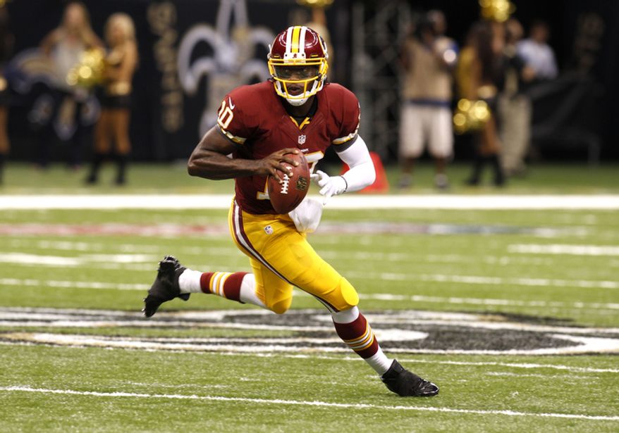 Washington Redskins quarterback Robert Griffin III (10) rushes in the first half of an NFL football game against the New Orleans Saints at the Mercedes-Benz Superdome in New Orleans, Sunday, Sept. 9, 2012. (AP Photo/Bill Haber)