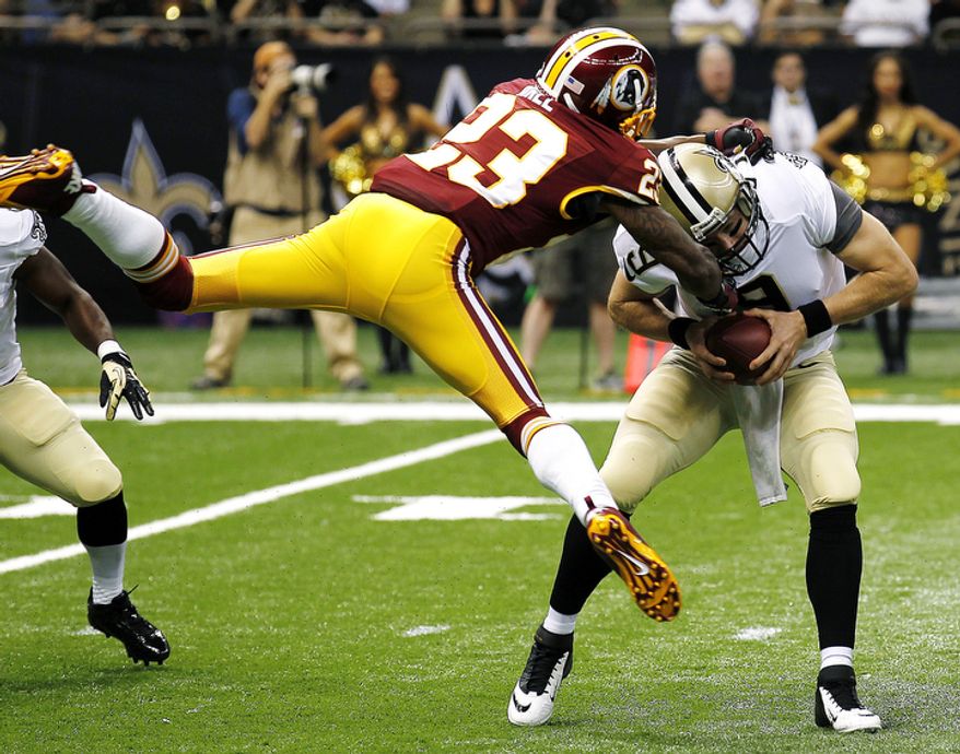 New Orleans Saints quarterback Drew Brees (9) is sacked by Washington Redskins cornerback DeAngelo Hall (23) in the first half of an NFL football game in New Orleans, Sunday, Sept. 9, 2012. The Redskins won 40-32. (AP Photo/Bill Haber)