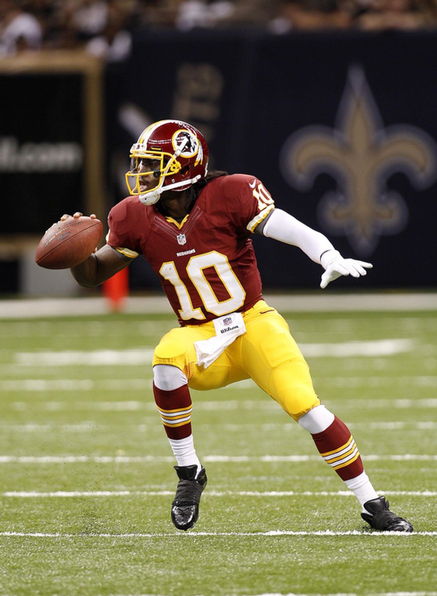 Washington Redskins quarterback Robert Griffin III (10) rushes in the first half of an NFL football game against the New Orleans Saints at the Mercedes-Benz Superdome in New Orleans, Sunday, Sept. 9, 2012. (AP Photo/Bill Haber)