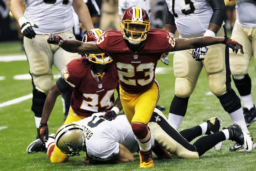 Washington Redskins cornerback DeAngelo Hall (23) reacts after sacking New Orleans Saints quarterback Drew Brees (9) in the first half of an NFL football game in New Orleans, Sunday, Sept. 9, 2012. (AP Photo/Bill Haber)