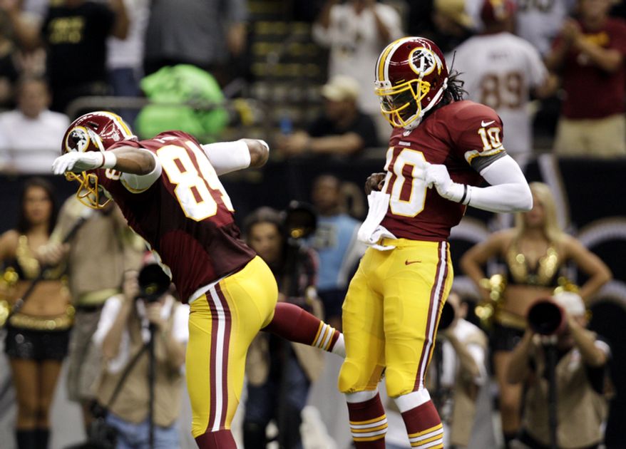 Washington Redskins quarterback Robert Griffin III (10) celebrates a touchdown with tight end Niles Paul (84) in the first half of an NFL football game at the Mercedes-Benz Superdome in New Orleans, Sunday, Sept. 9, 2012. (AP Photo/Matthew Hinton)