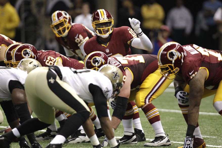 Washington Redskins quarterback Robert Griffin III (10) calls a play in the second half of an NFL football game against the New Orleans Saints at the Mercedes-Benz Superdome in New Orleans, Sunday, Sept. 9, 2012. (AP Photo/Matthew Hinton)