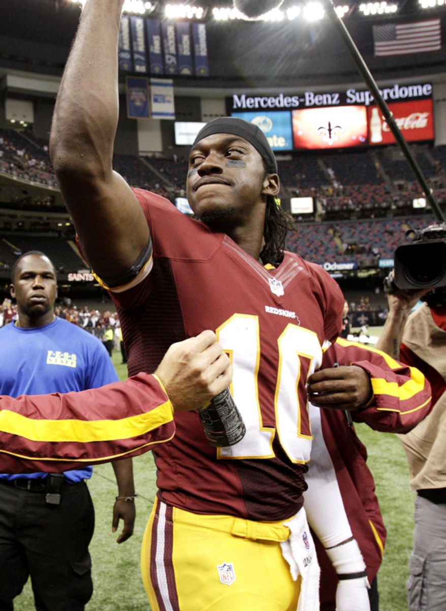 Washington Redskins quarterback Robert Griffin III (10) reacts to the crowd after an NFL football game against the New Orleans Saints at Mercedes-Benz Superdome in New Orleans, Sunday, Sept. 9, 2012. The Redskins won 40-32. (AP Photo/Matthew Hinton)