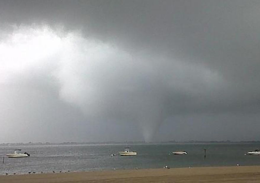 This photo provided by Joey Mure shows a storm cloud over the Breezy Point area of the Queens borough of New York on Saturday, Sept. 8, 2012. (AP Photo/Joey Mure)