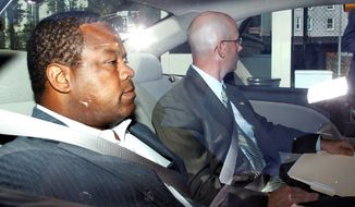 In this 2012 file photo, then-Trenton, N.J., Mayor Tony Mack (left) is driven to the federal courthouse in the capital after agents arrested him as part of an ongoing corruption investigation into bribery allegations related to a parking garage project that was concocted as part of an FBI sting operation. (Associated Press)