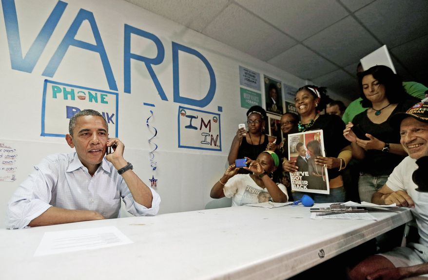 President Obama uses a cellphone to contact supporters during a surprise visit to meet campaign workers at an Obama campaign office Sunday in Port St. Lucie, Fla. Florida is considered the biggest prize among the swing states up for grabs. (Associated Press)