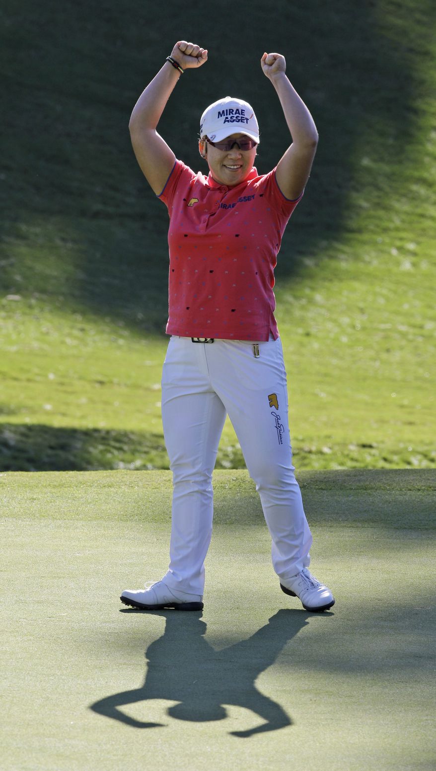 Jiyai Shin, of South Korea, celebrates winning the Kingsmill Championship LPGA Tour golf tournament in Williamsburg, Va., Monday, Sept. 10, 2012. Shin won the tournament in a nine-hole playoff with Paula Creamer. (AP Photo/Steve Helber)