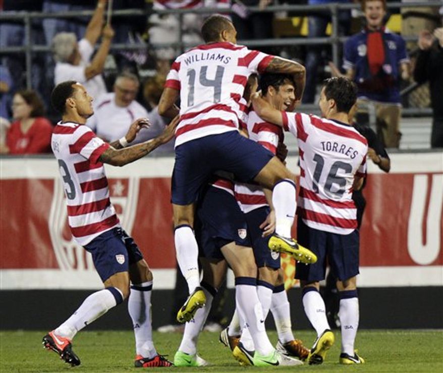 United States players celebrate a goal by Herculez Gomez against Jamaica during the second half of a World Cup qualifying soccer match, Tuesday, Sept. 11, 2012, in Columbus, Ohio. The United States won 1-0. (AP Photo/Jay LaPrete)